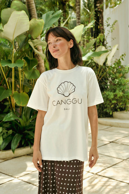 Woman wearing a white t-shirt with 'Canggu Bali' design in a tropical setting
